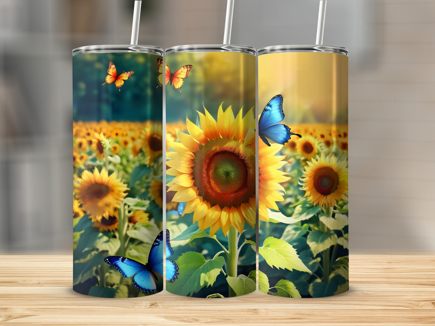 Three tumblers featuring sunflowers and butterflies on a wooden surface.