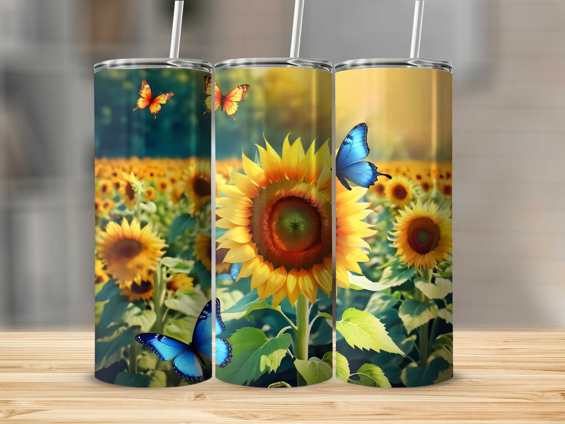 Three tumblers featuring sunflowers and butterflies on a wooden surface.