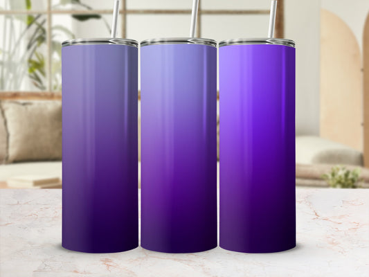 Three gradient purple tumblers with straws on a marble surface.