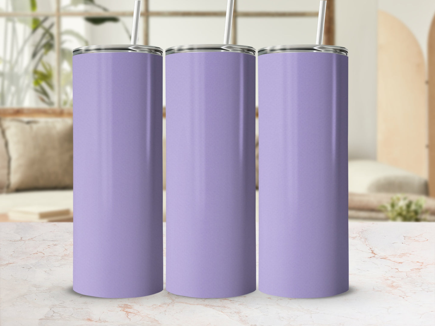 Three plain lavender tumblers with straws stand on a marble countertop.