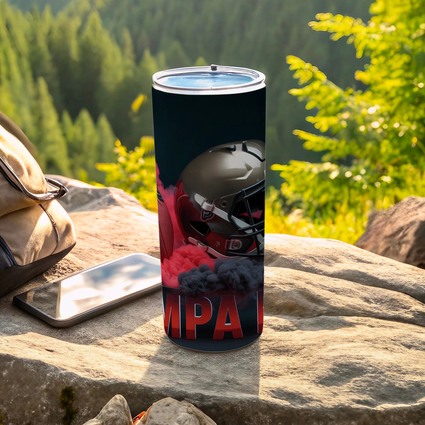 Black tumbler with football helmet and "IMPACT" text, outdoors.