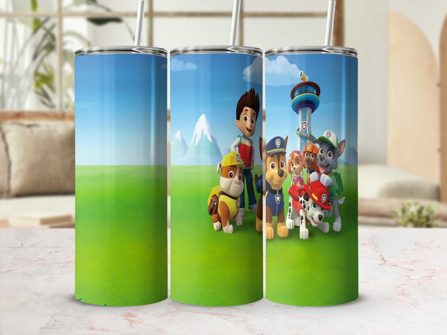 Paw Patrol characters Ryder, Chase, Marshall, and Rubble on green grassy background.