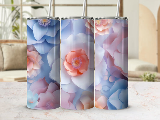 Three tall, floral-patterned tumblers with straws on a marbled surface.
