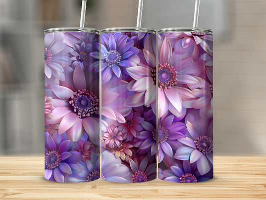 Three purple floral tumblers with straws on a wooden surface.