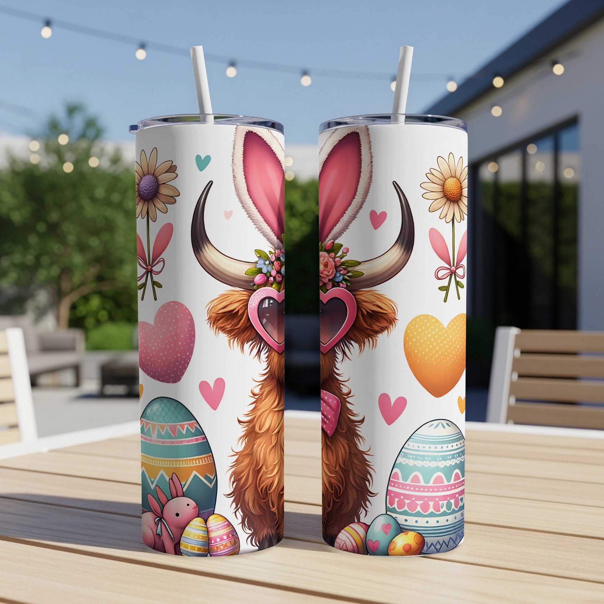 Two tall, narrow tumblers with Easter-themed designs and bunny ears.