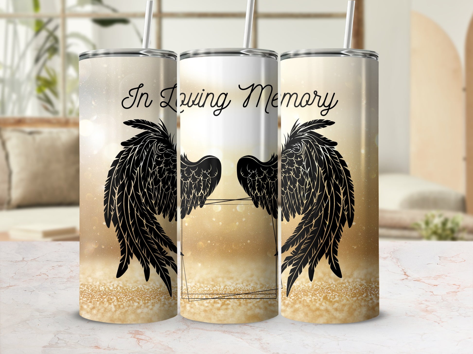 Three tumblers with "In Loving Memory" and black angel wings on gold glitter background.