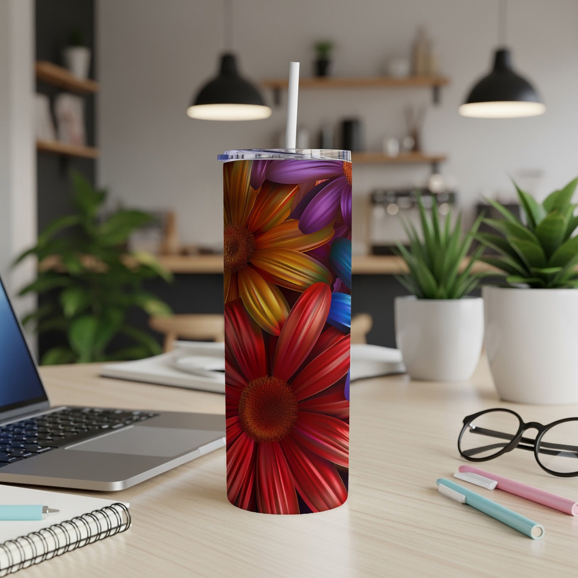 Colorful floral pattern tumbler with straw on a desk.