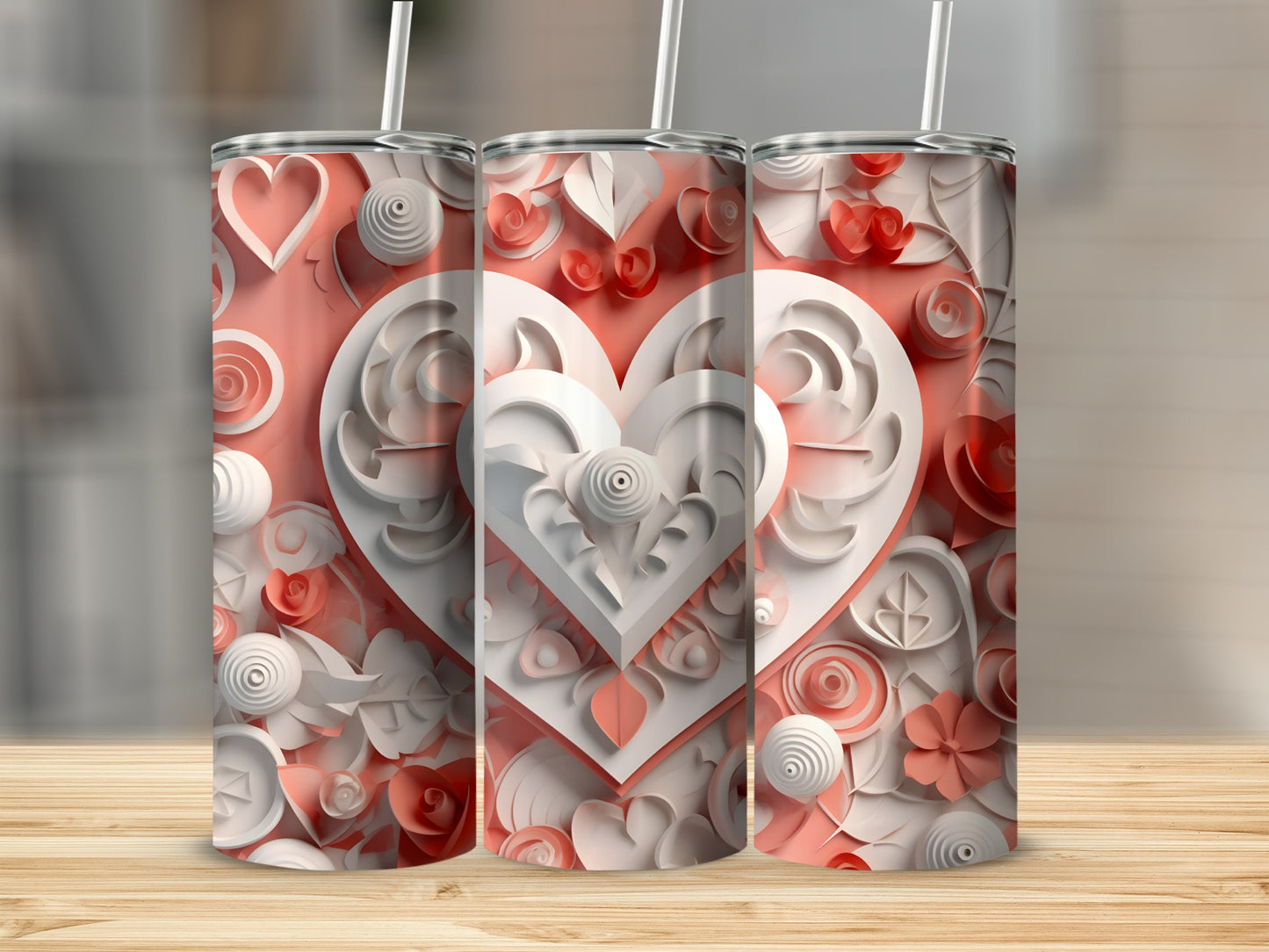 Three coral tumblers with heart and floral paper art designs.