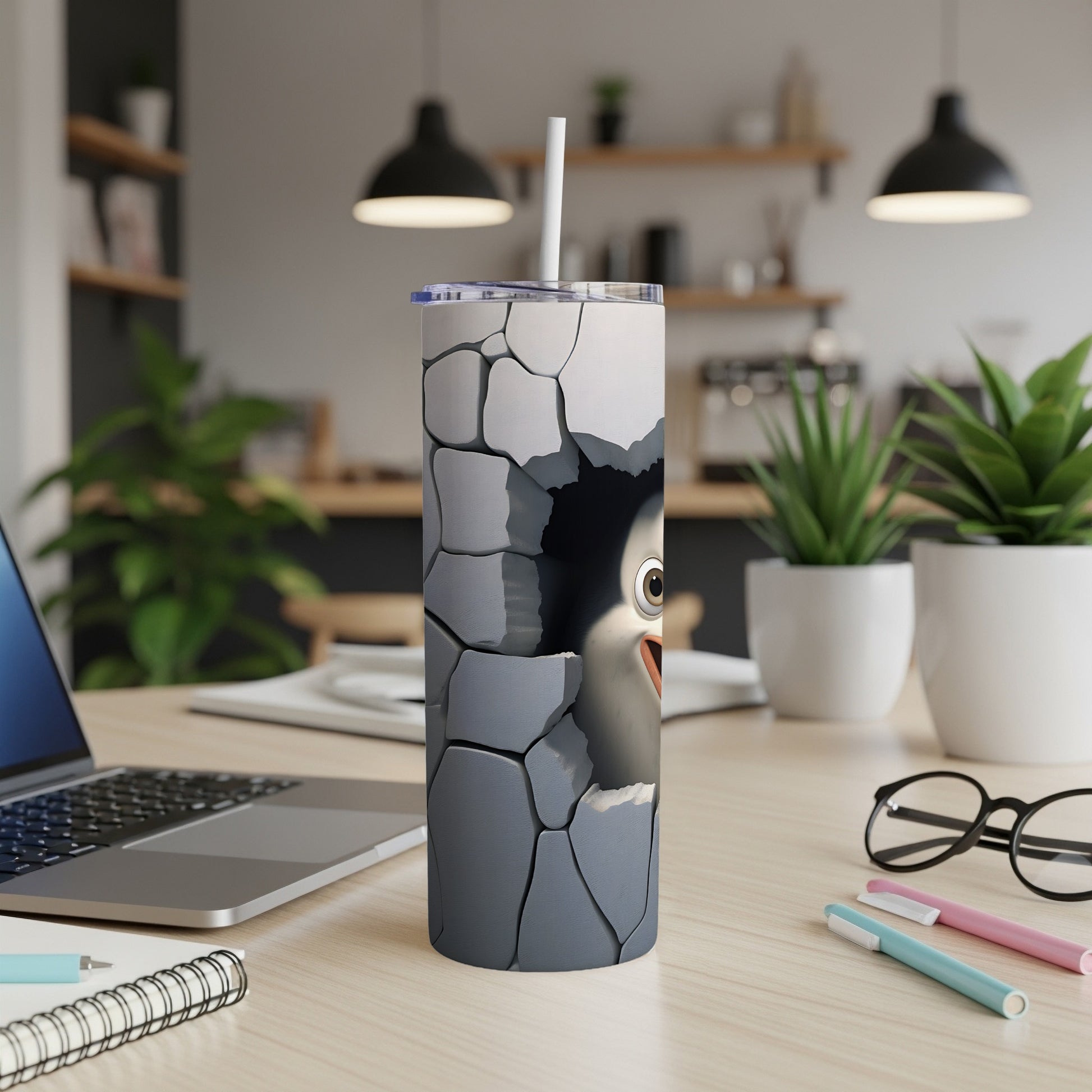 Tall tumbler with a cartoon penguin face breaking through a cracked wall design.