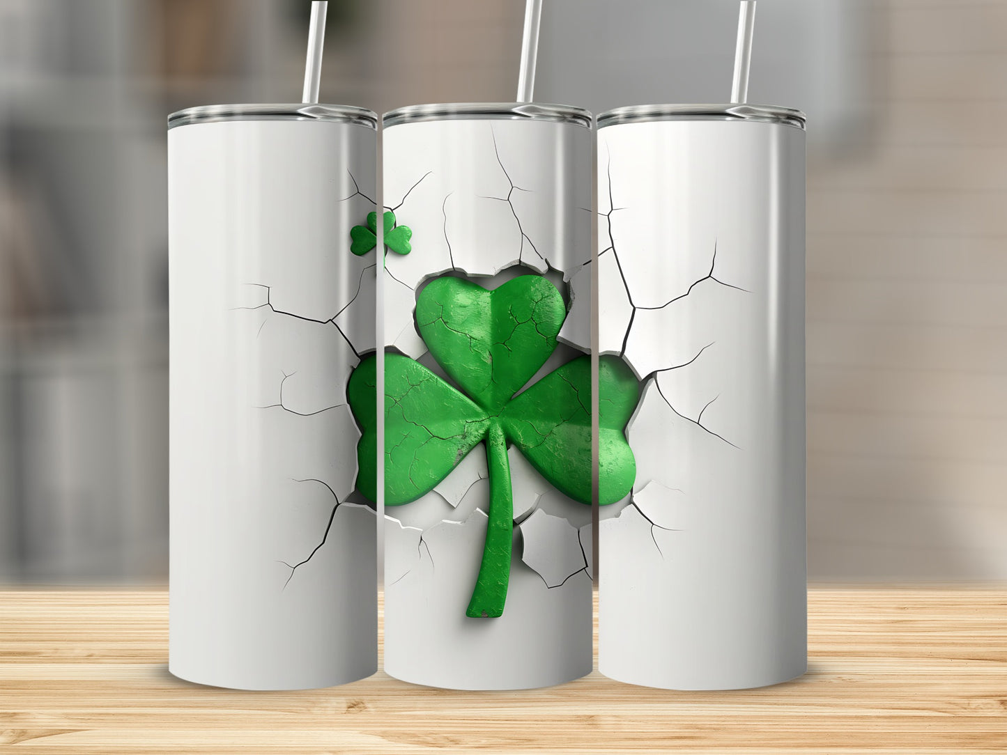 Three white tumblers with cracked fronts revealing a green shamrock.