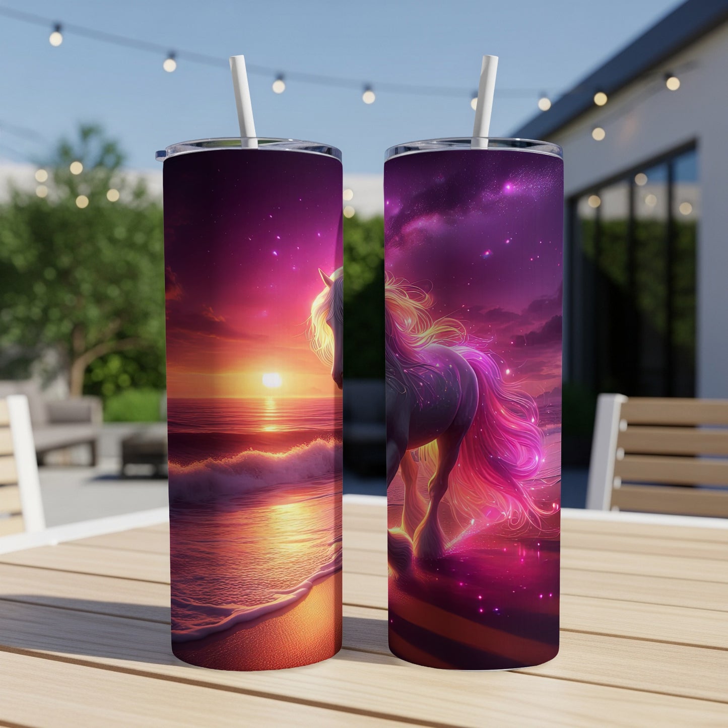 Two tumblers with a sunset and unicorn design displayed on a table.