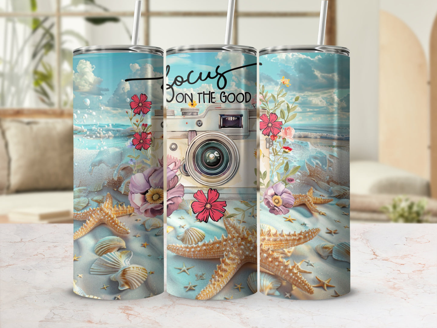 Tumbler with vintage camera, starfish, shells, and flowers on beach background.