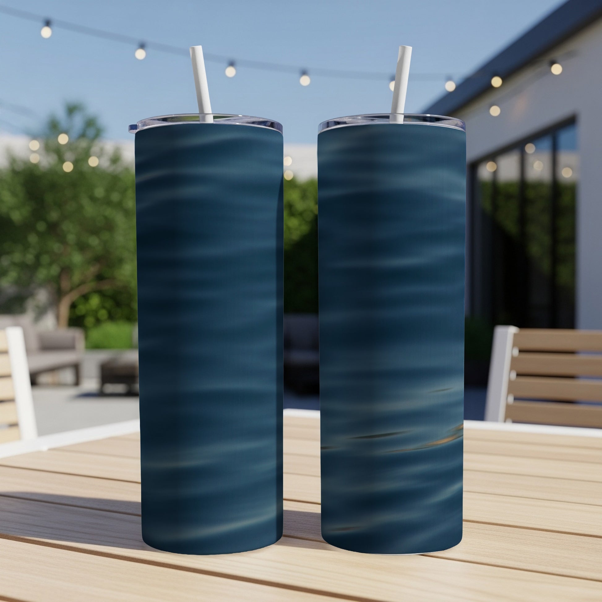 Two tumblers with a blue wavy water pattern sit on a wooden table.