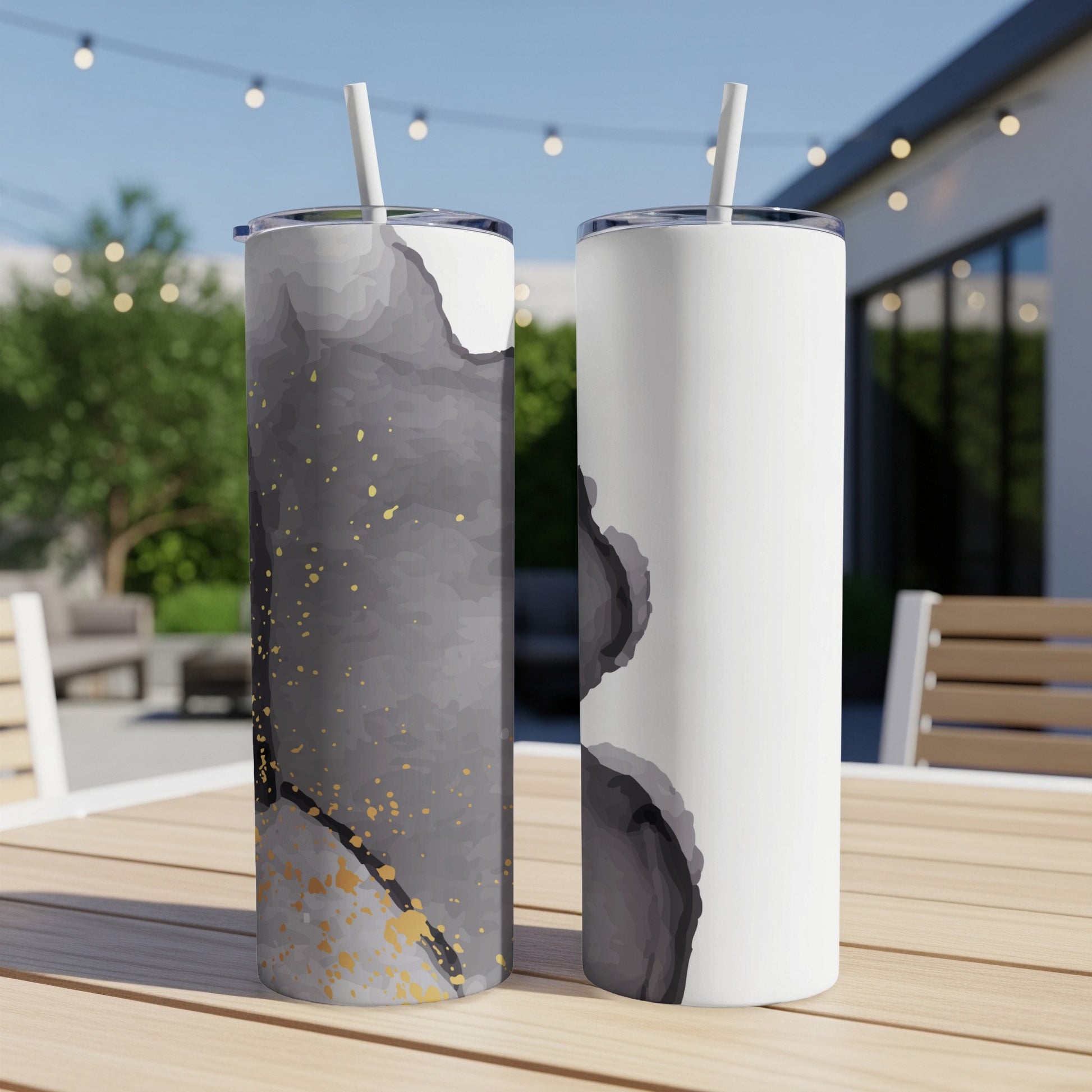 Two tall tumblers, one black and gold abstract, one white with abstract gray.