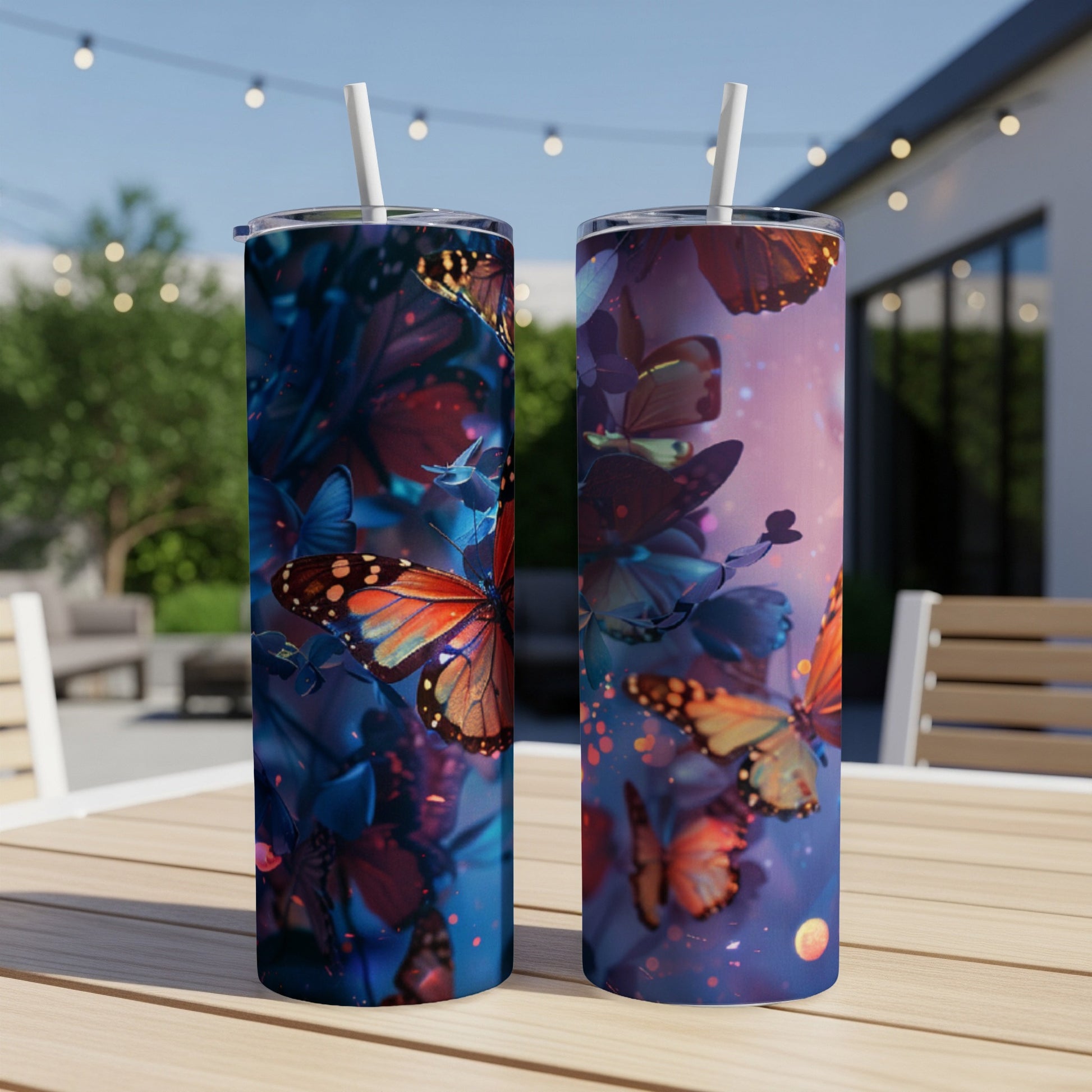 Two cylindrical tumblers with a vibrant butterfly and floral design.