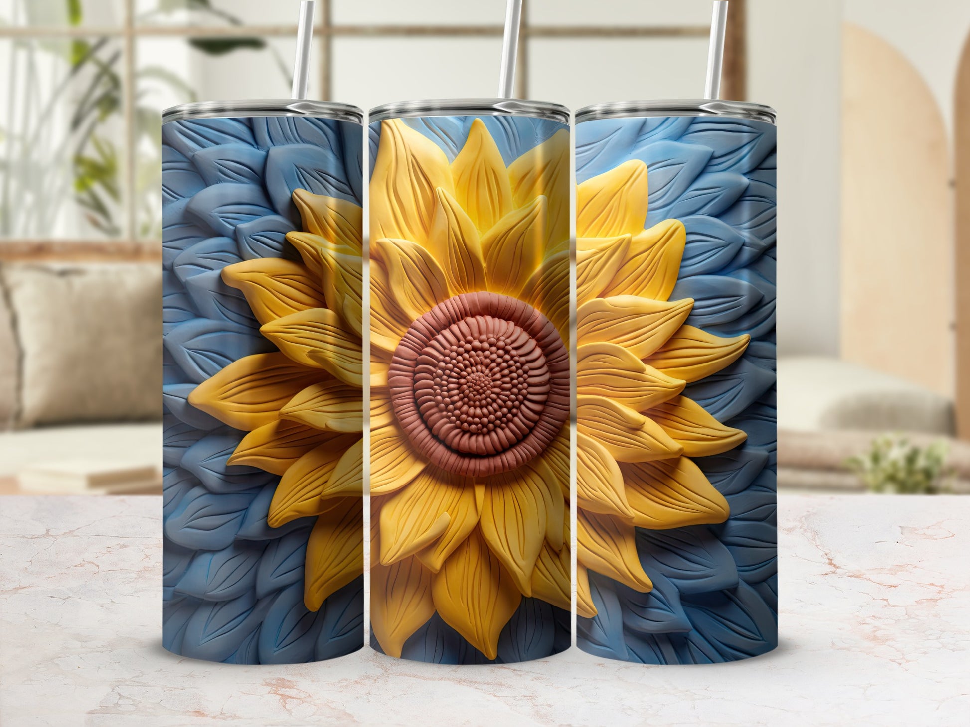 Three tumblers featuring a large, textured sunflower on a blue background.