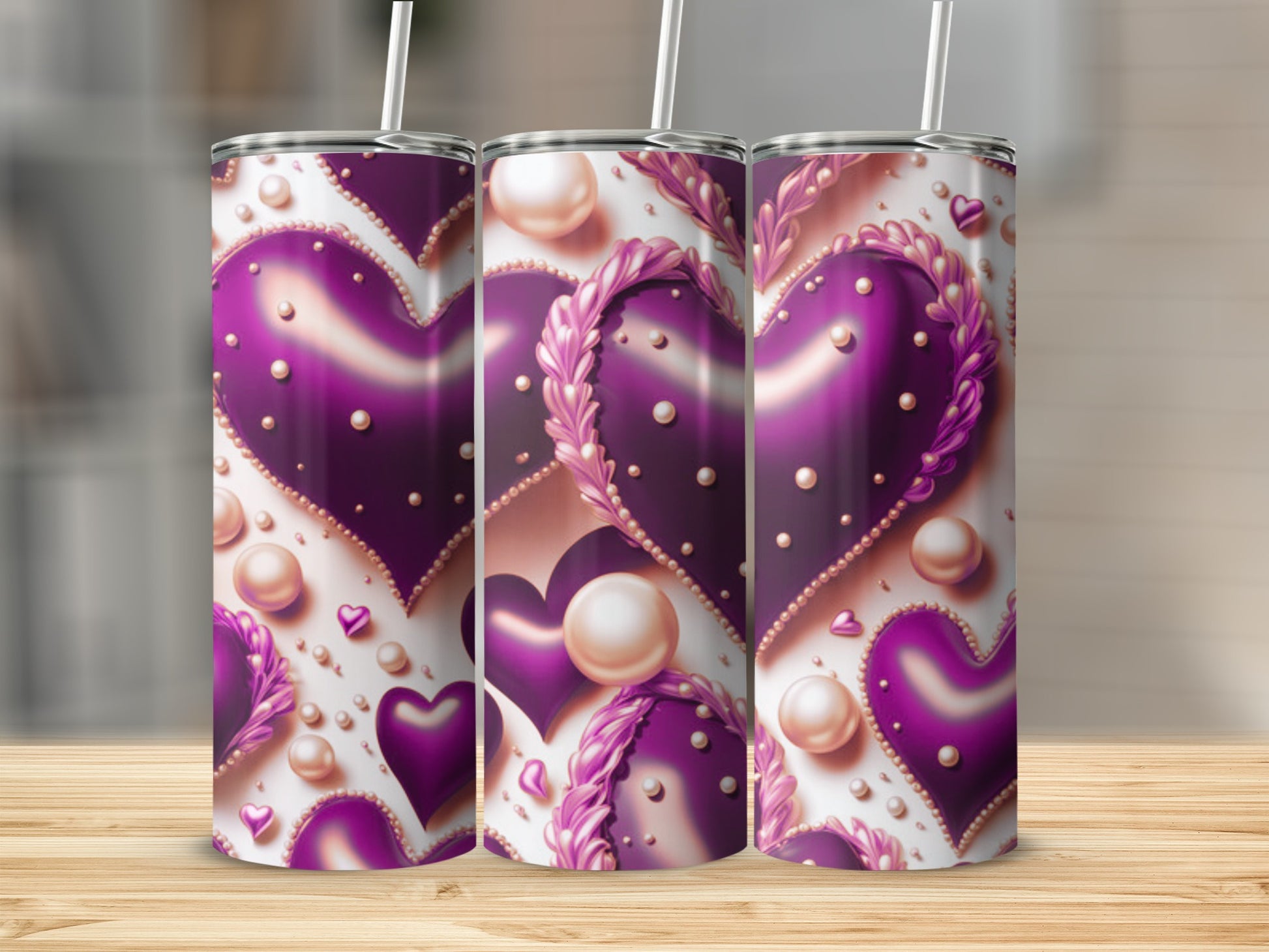Three purple heart tumblers with pearl accents and a straw.
