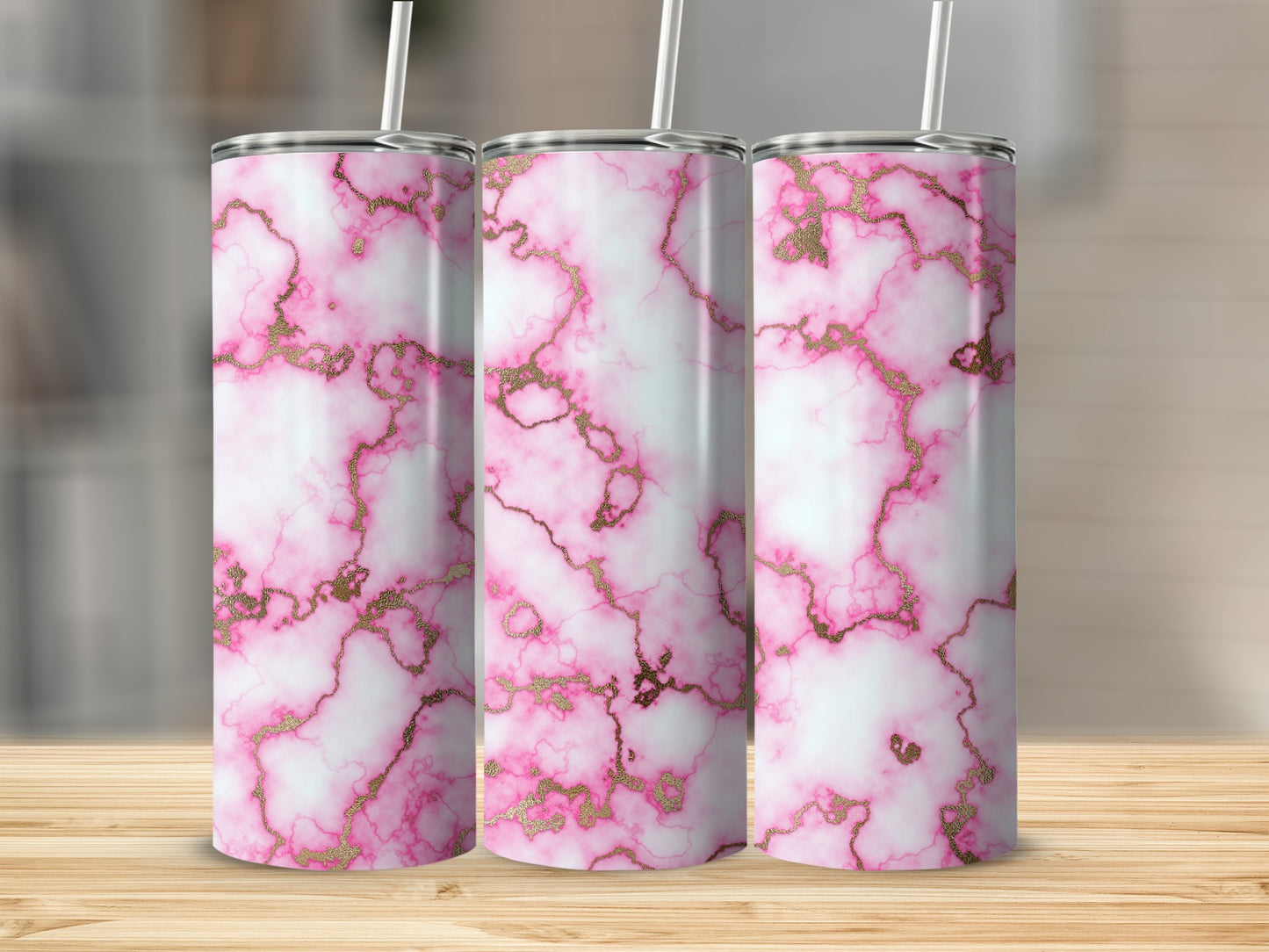 Three pink marble tumblers with gold veining and white straws.