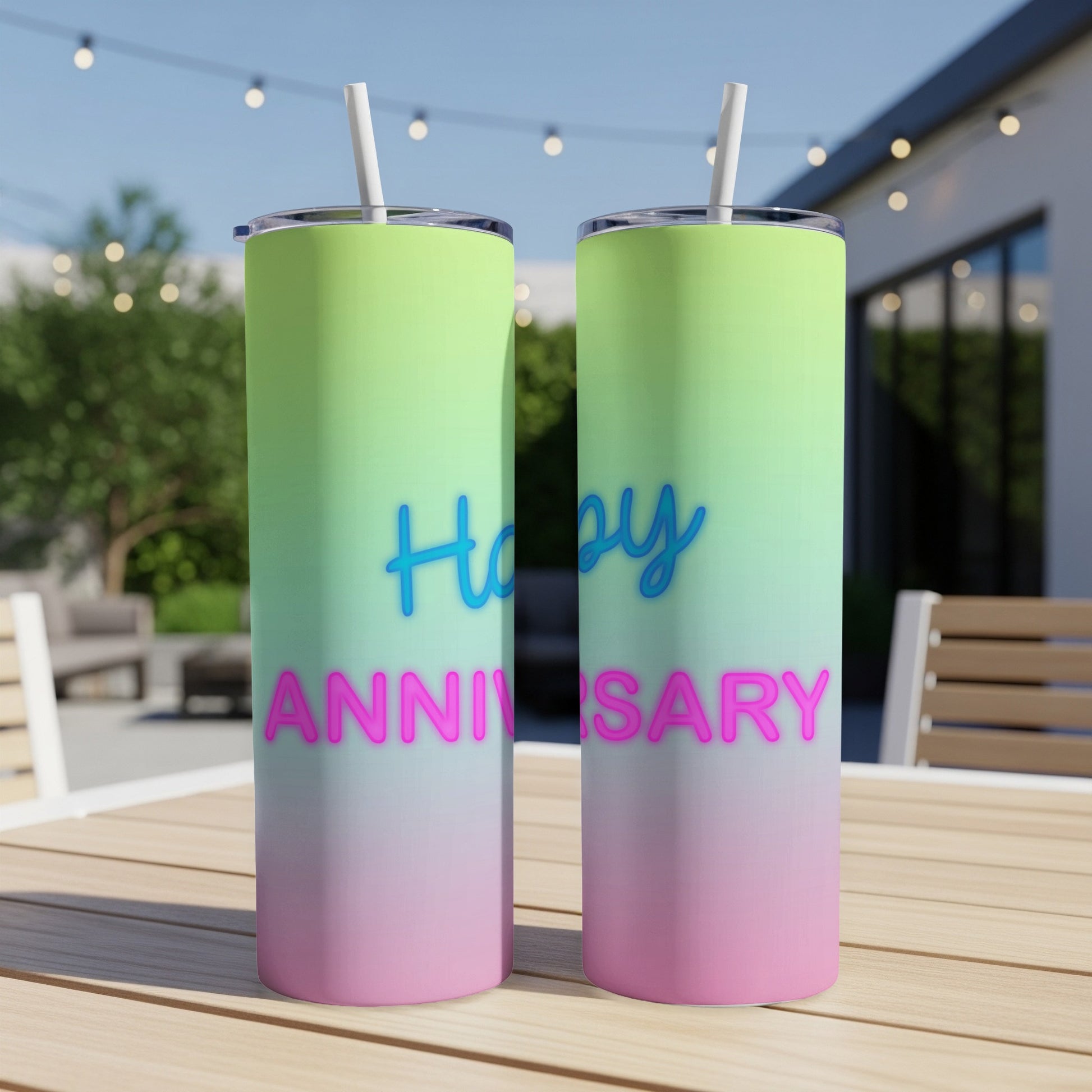 Two tall tumblers with "Happy Anniversary" text, gradient background, on a table.