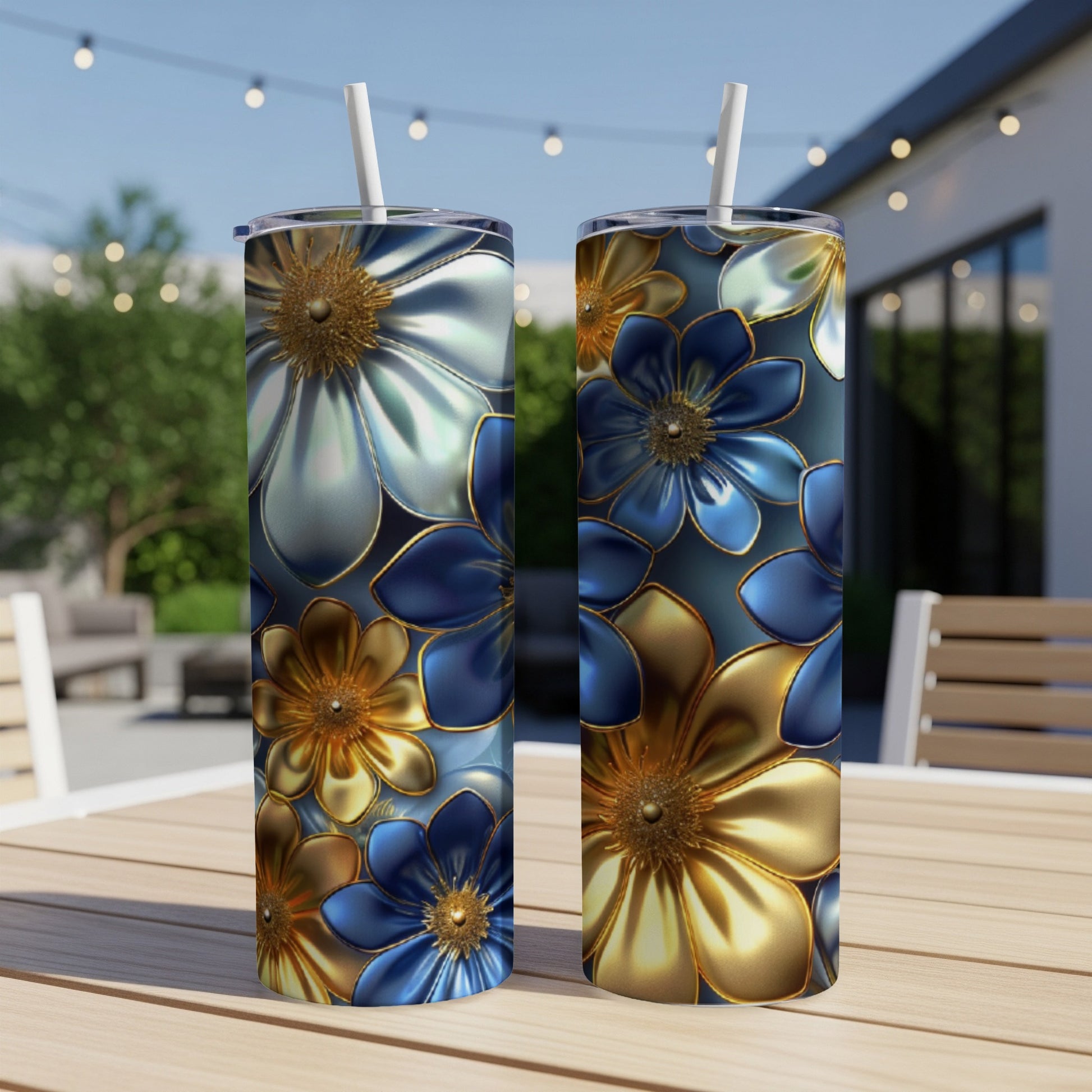 Two tall tumblers with metallic blue and gold floral patterns on a wooden table.