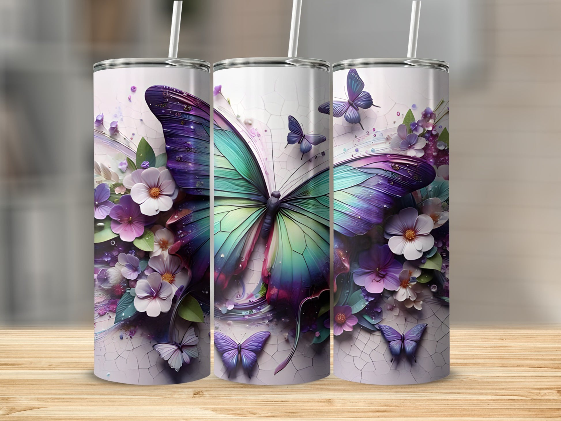 Three tumblers with a purple and green butterfly and floral design.