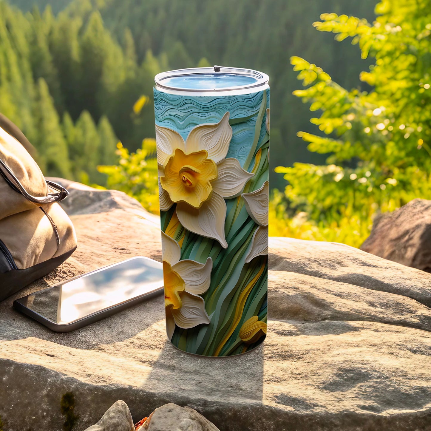 3D relief of yellow daffodils and green leaves on a white tumbler.
