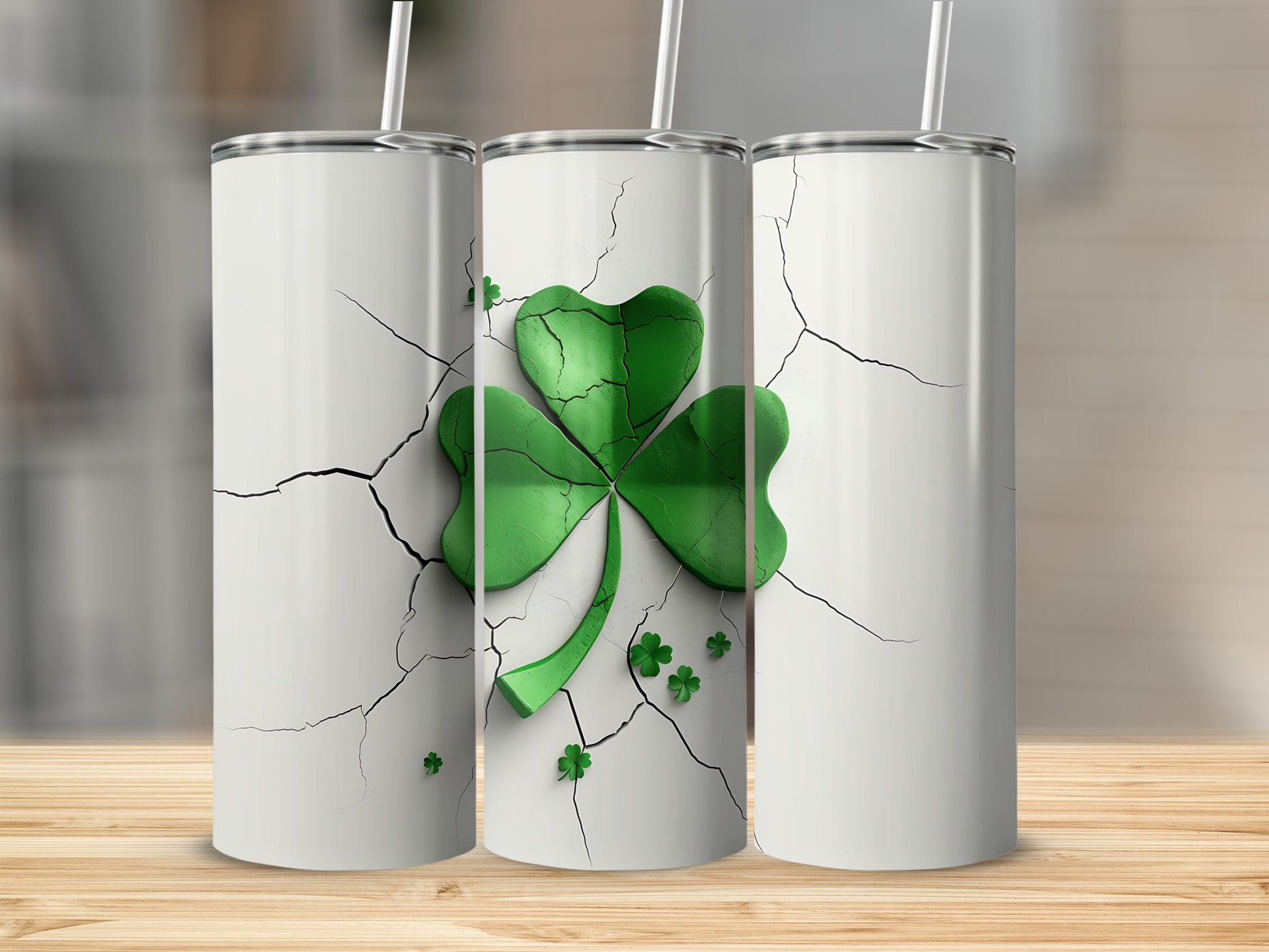 Three white tumblers with a cracked design and green shamrock decoration.
