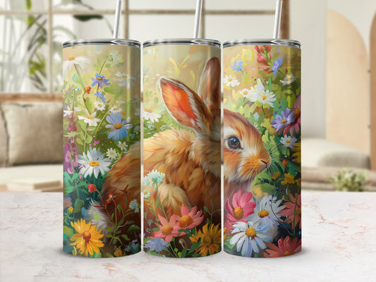 Three tumblers with a rabbit in a field of flowers.