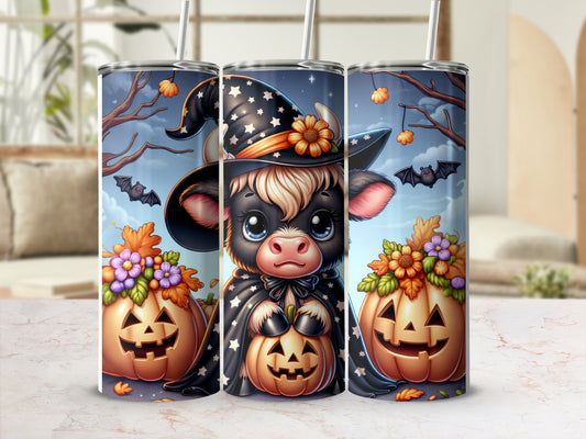 Halloween tumbler with a cartoon cow in a witch hat and pumpkins.