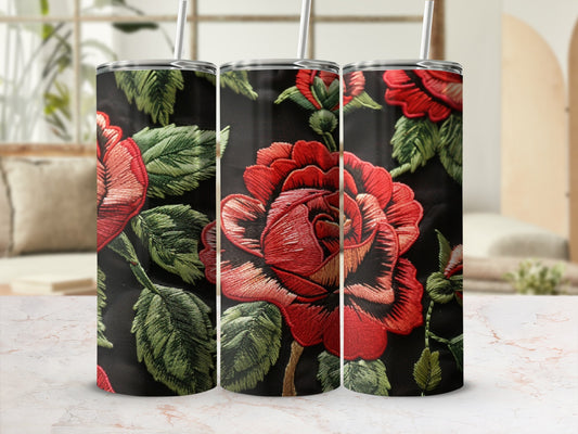 Floral embroidered tumbler with red roses and green leaves on black background.