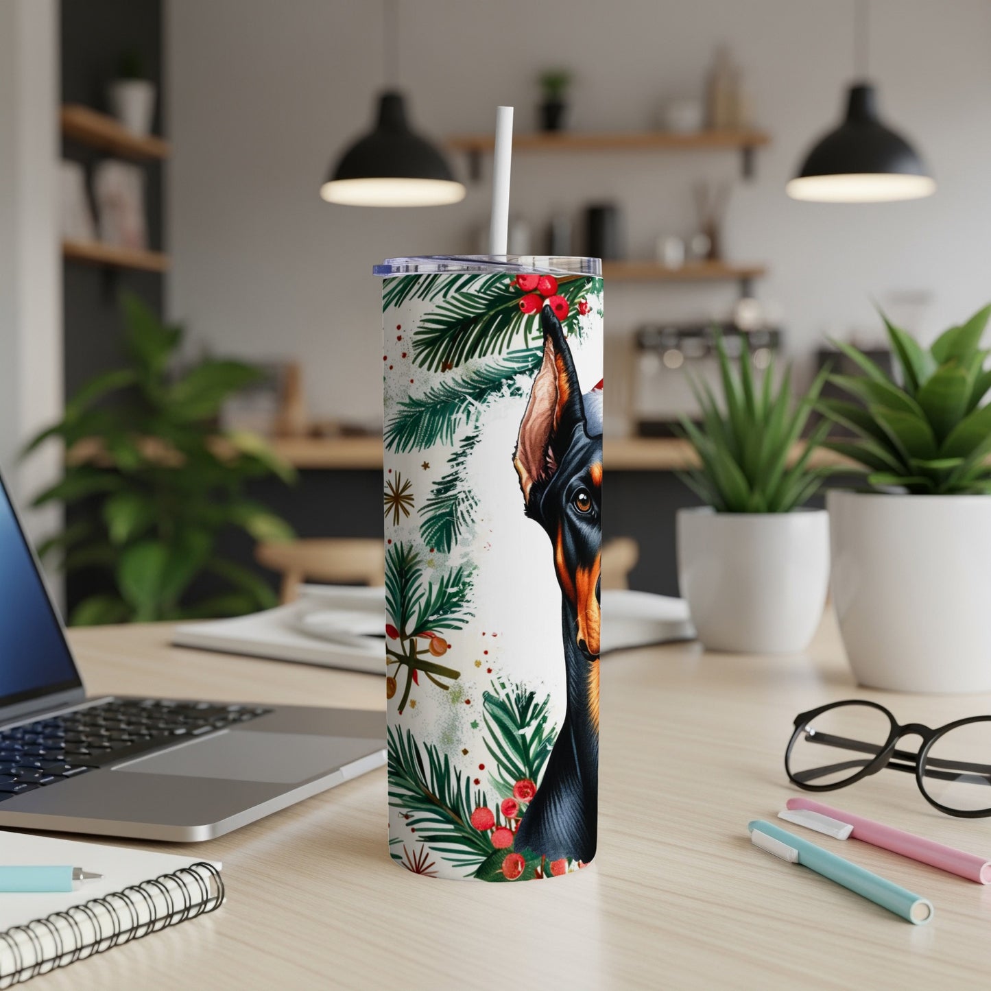 Doberman head with festive greenery on a tumbler with a straw.
