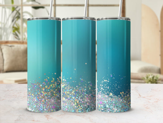 Three teal tumblers with gradient glitter accents and metal straws.