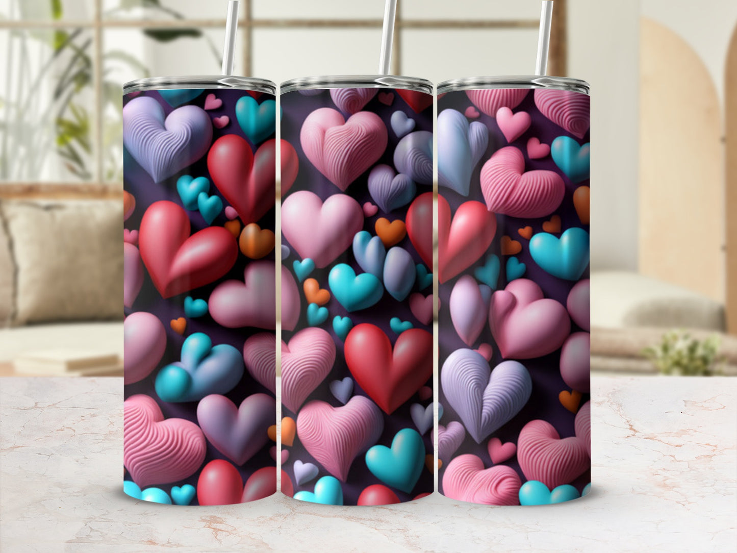 Three colorful tumblers with a textured heart pattern and straws.
