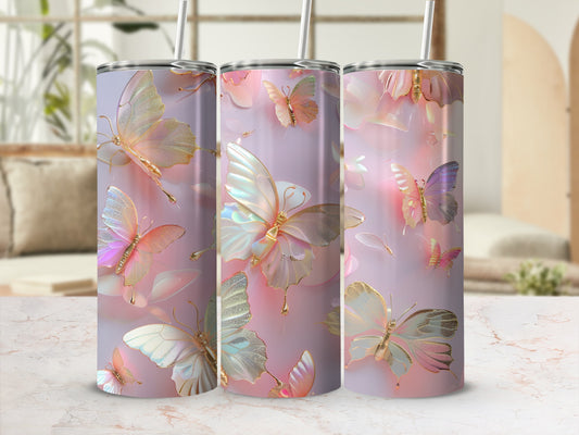Three tumblers with pastel butterfly and floral designs on a marble surface.