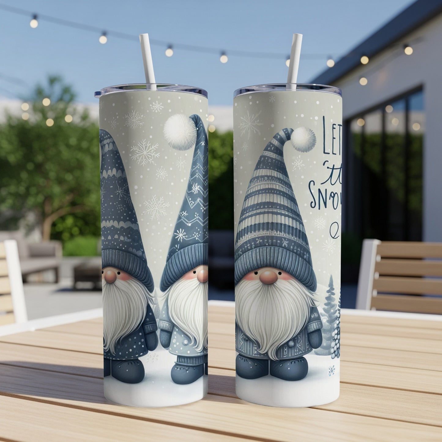 Two gnome tumblers with "Let it Snow" text, on a table.