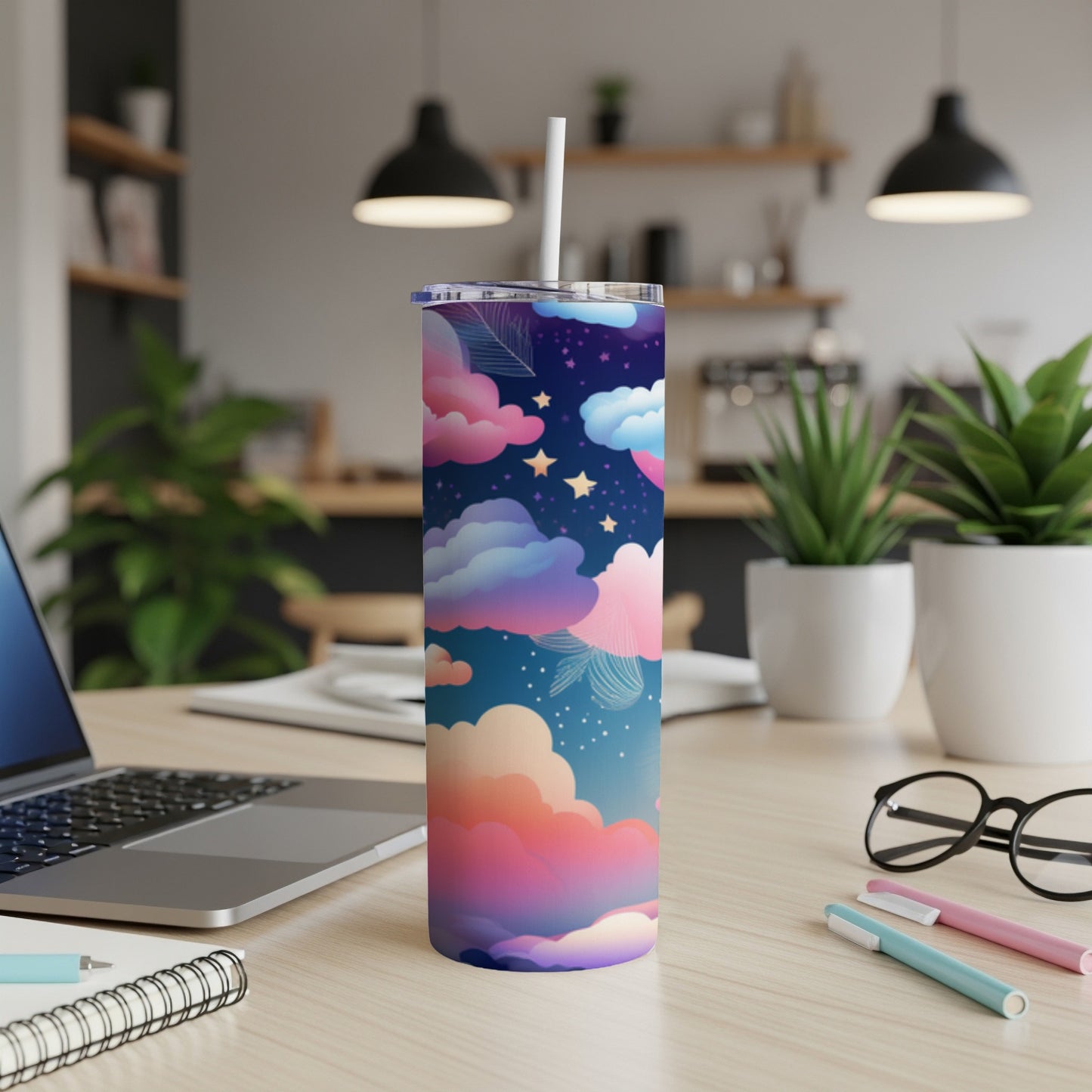 Tall tumbler with a celestial cloud and star pattern on a desk.