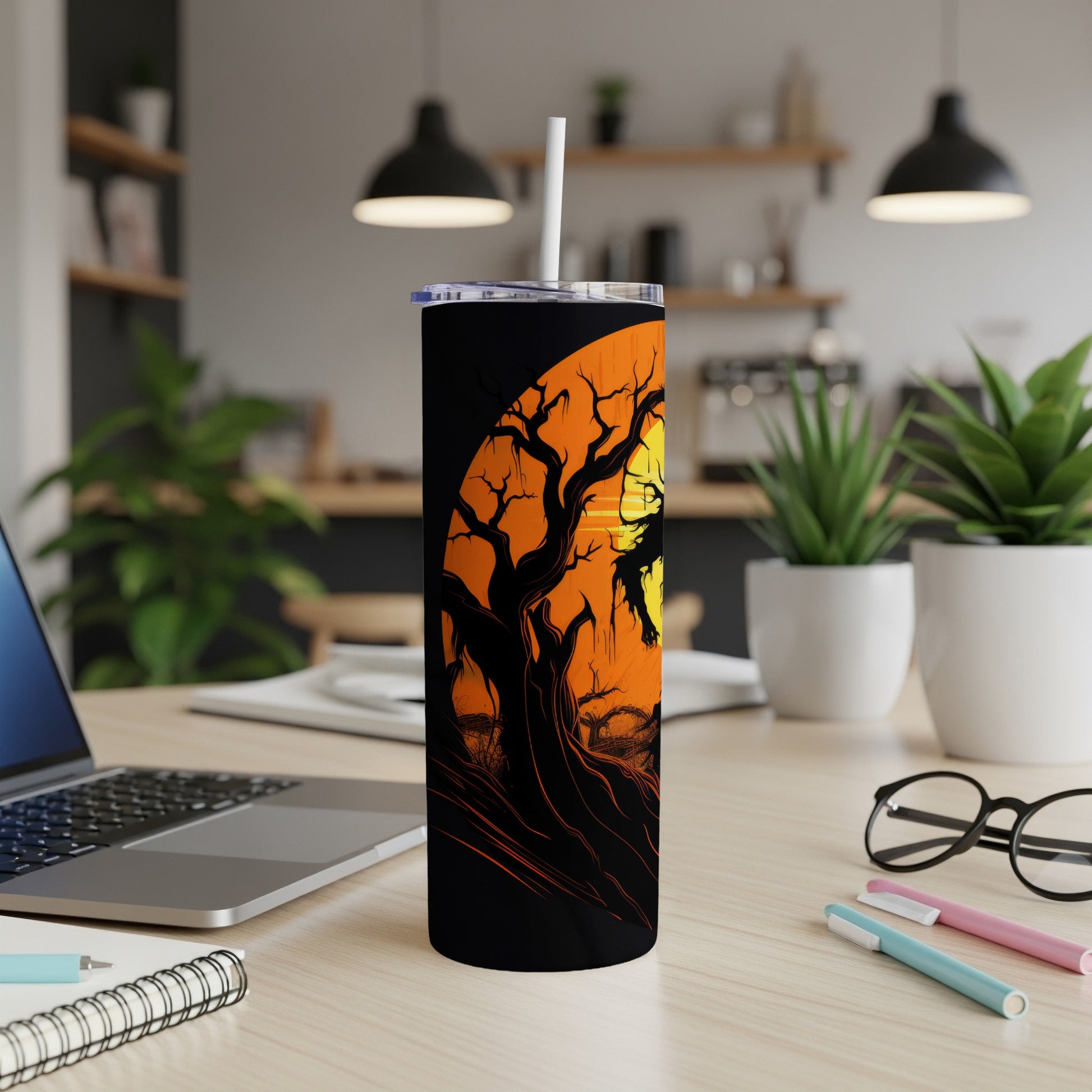 Black tumbler with spooky tree and moon Halloween design.