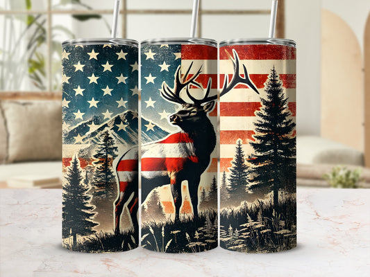 Deer with American flag motif on a tumbler with mountains and trees.