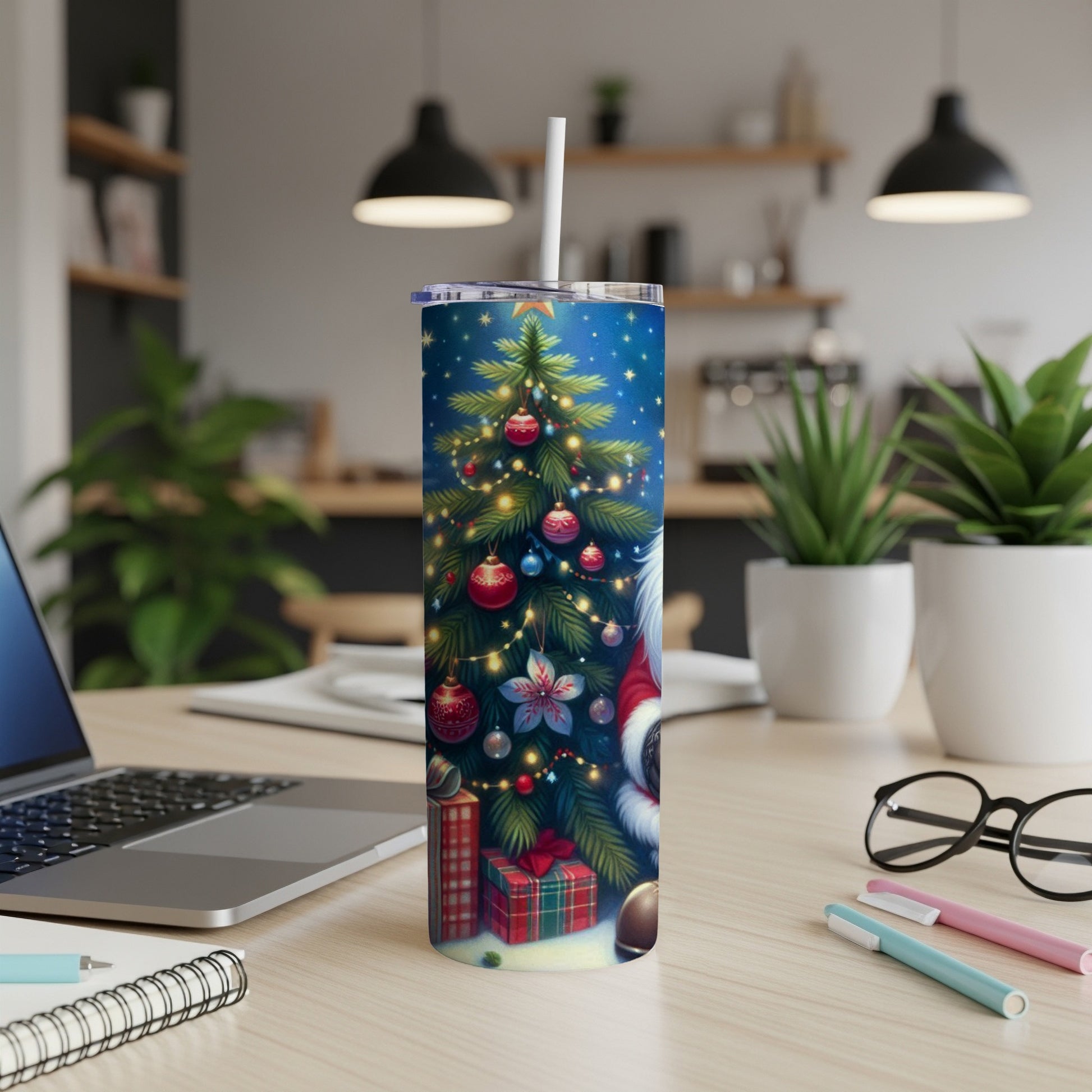 Christmas-themed tumbler with Santa Claus illustration and gifts on desk.