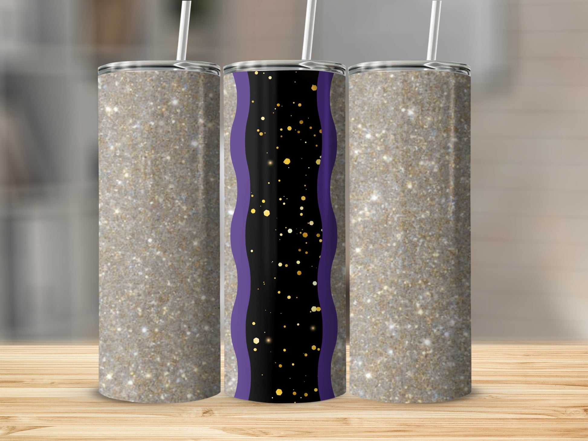 Three glittery tumblers with a purple and gold wavy design on the middle one.