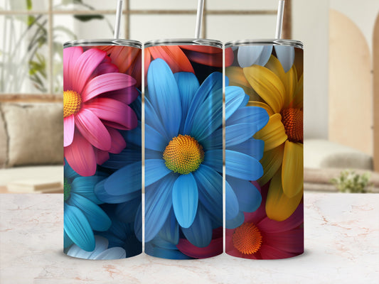 Three colorful floral tumblers with straws on a marble surface.