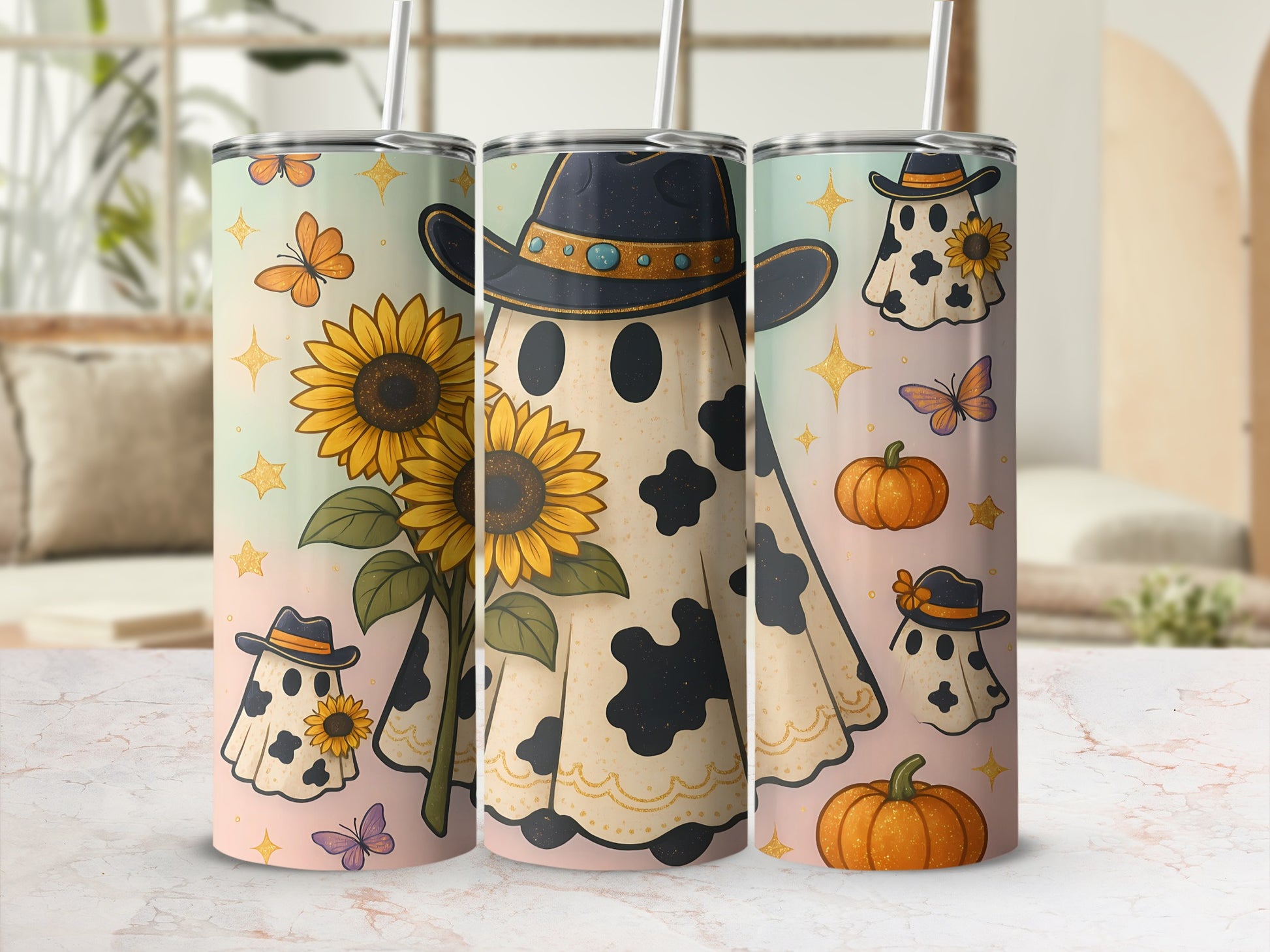 Three tumblers with cow-spotted ghosts wearing cowboy hats and sunflowers.