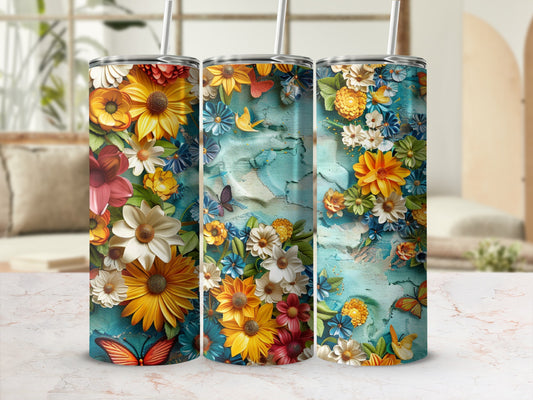 Tumblers with vibrant floral patterns and butterflies on textured backgrounds.