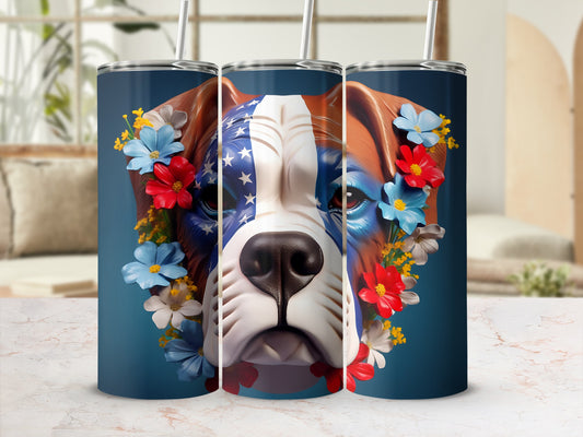 Dog wearing American flag bandana surrounded by flowers on a blue tumbler.