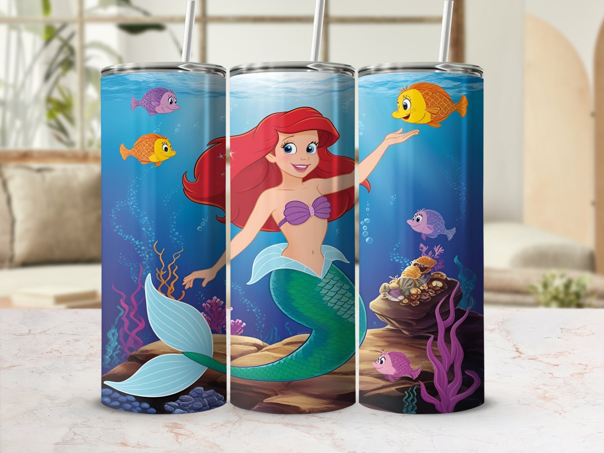Ariel the mermaid with fish and coral reef background.