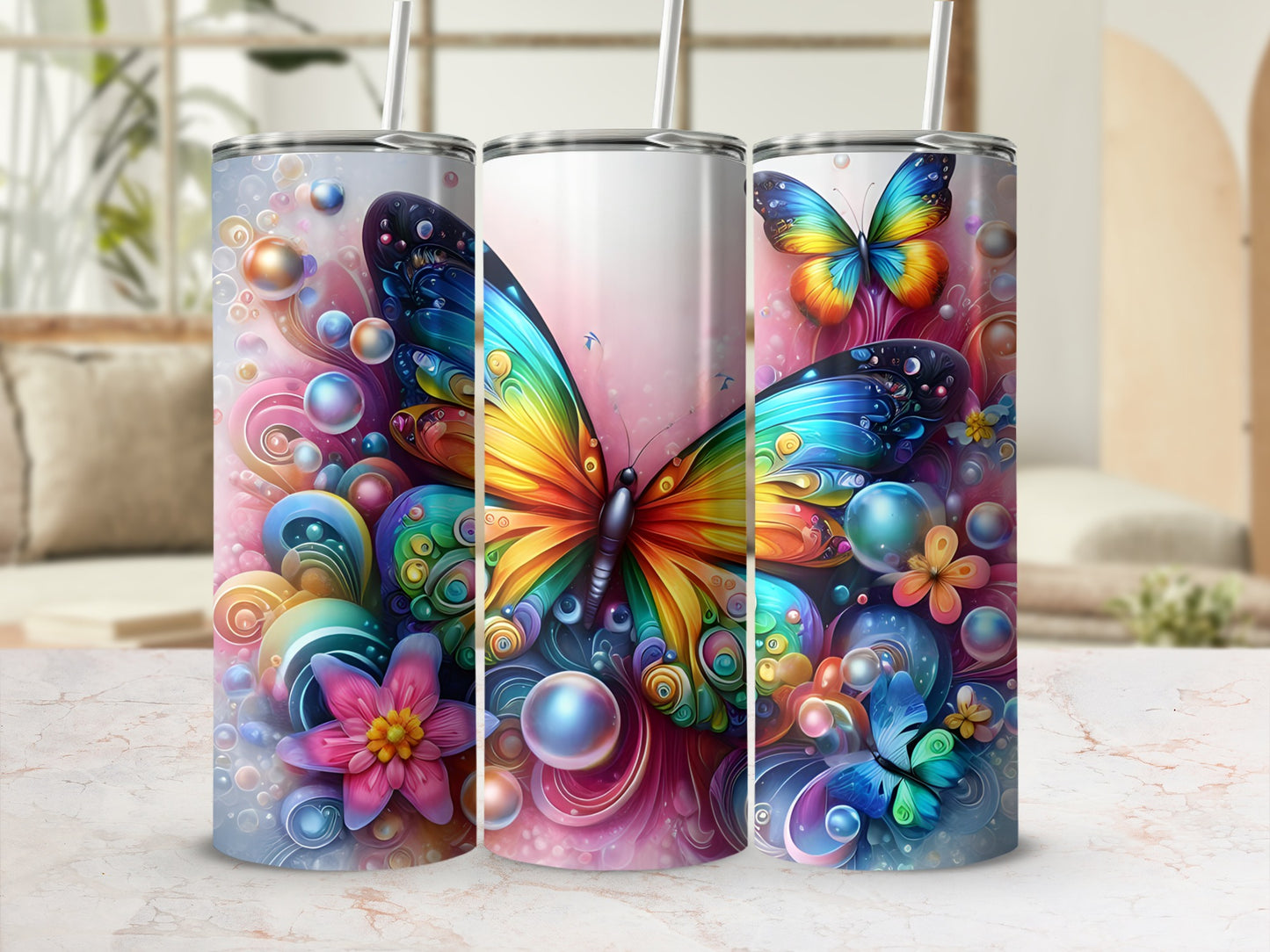 Three tumblers with colorful butterfly and floral designs.