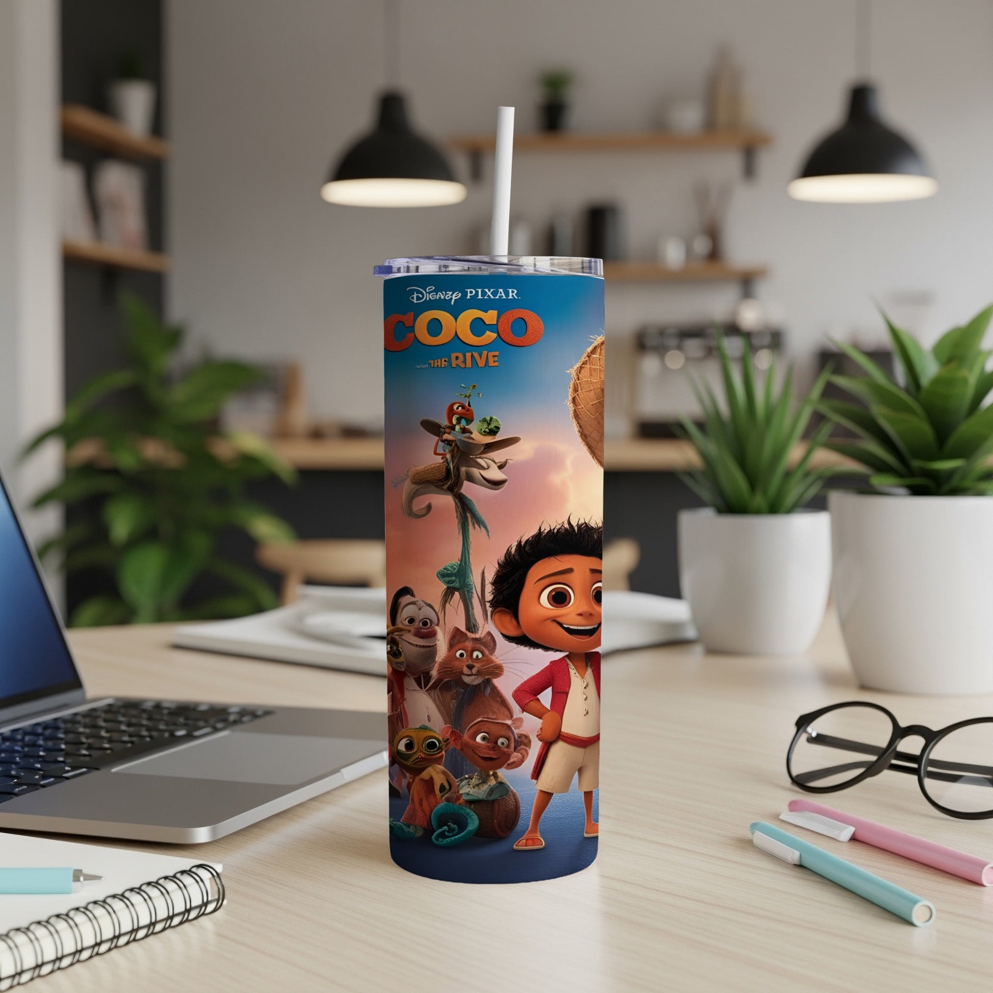 Coco movie characters on a white insulated tumbler with a straw.