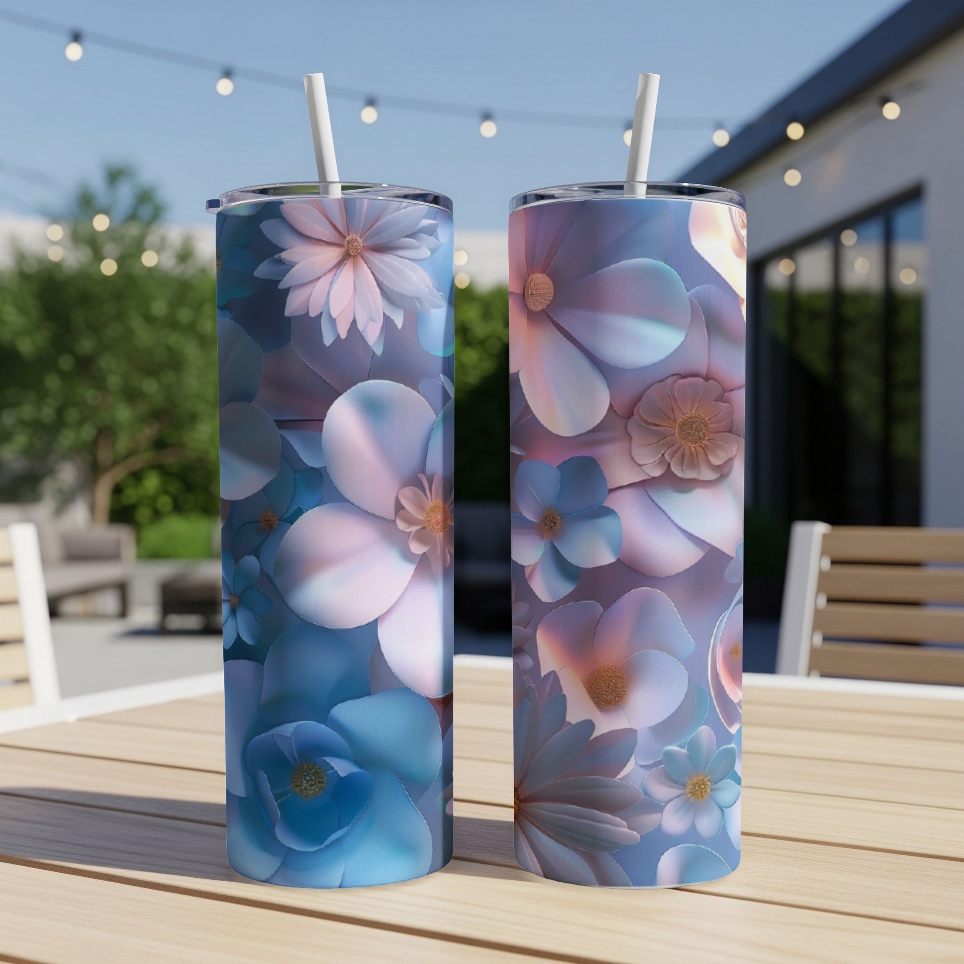 Two tall tumblers with blue and pink floral designs stand on a wooden table.