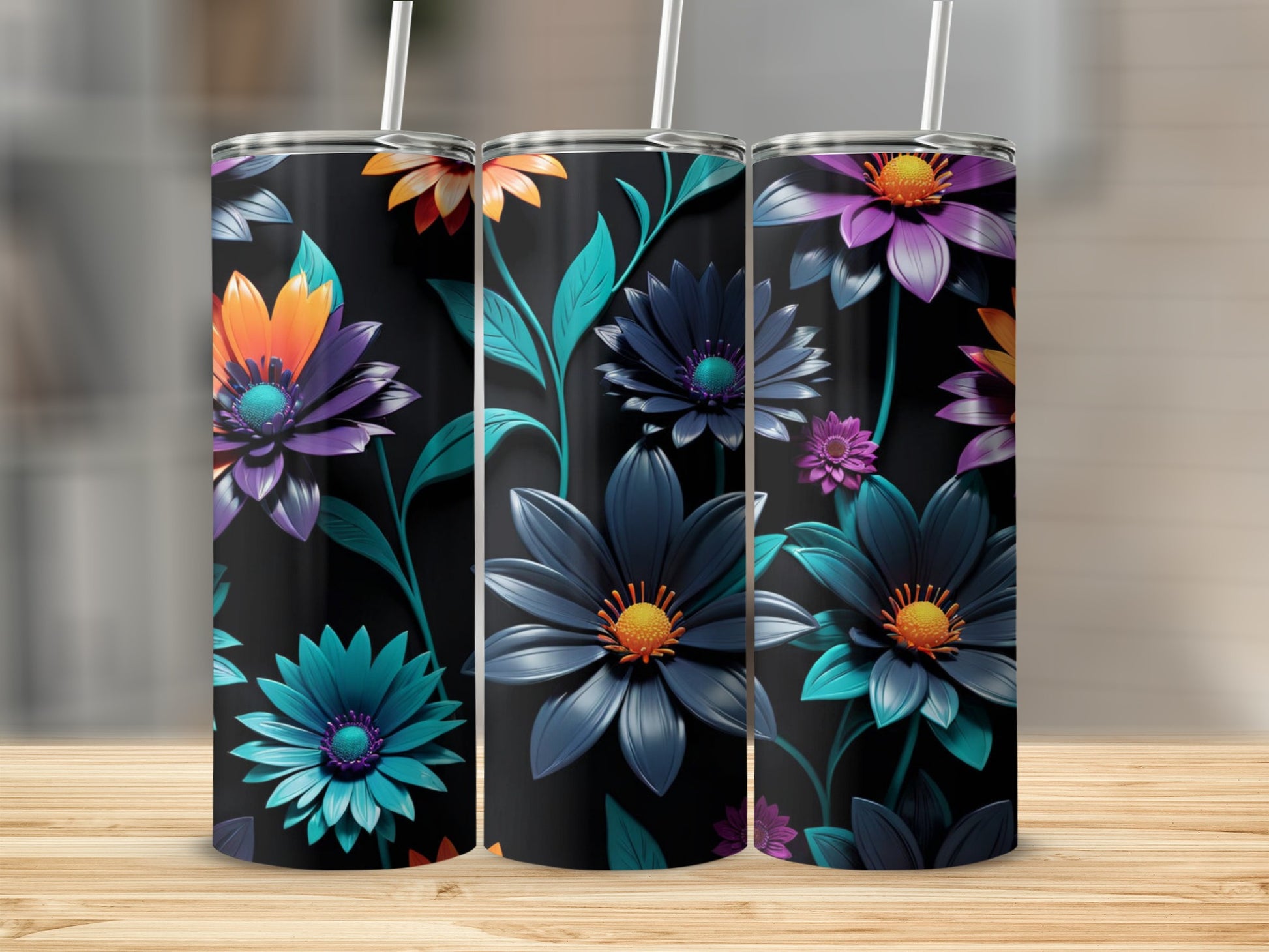 Three tumblers with colorful floral designs on a wooden surface.
