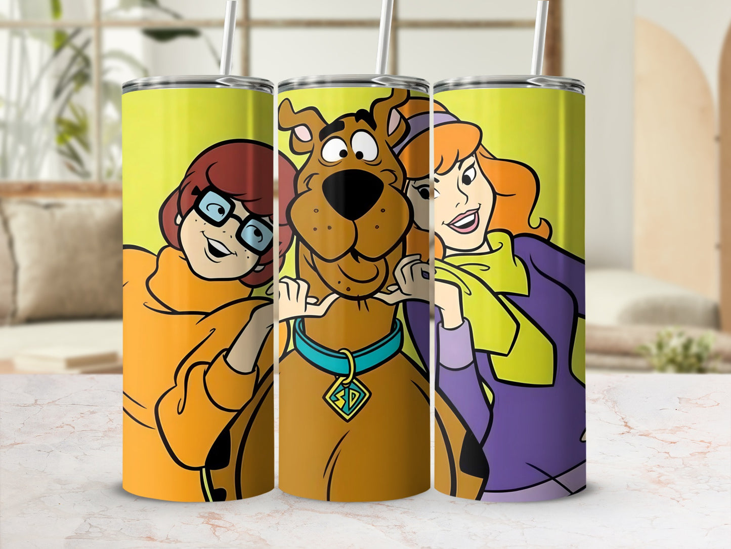 Scooby-Doo characters Fred, Daphne, Velma, and Scooby-Doo on a yellow tumbler.
